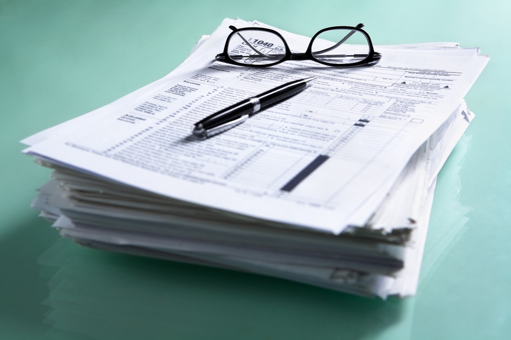 A stack of IRS tax returns, which accountants and finance professionals often handle in a variety of roles